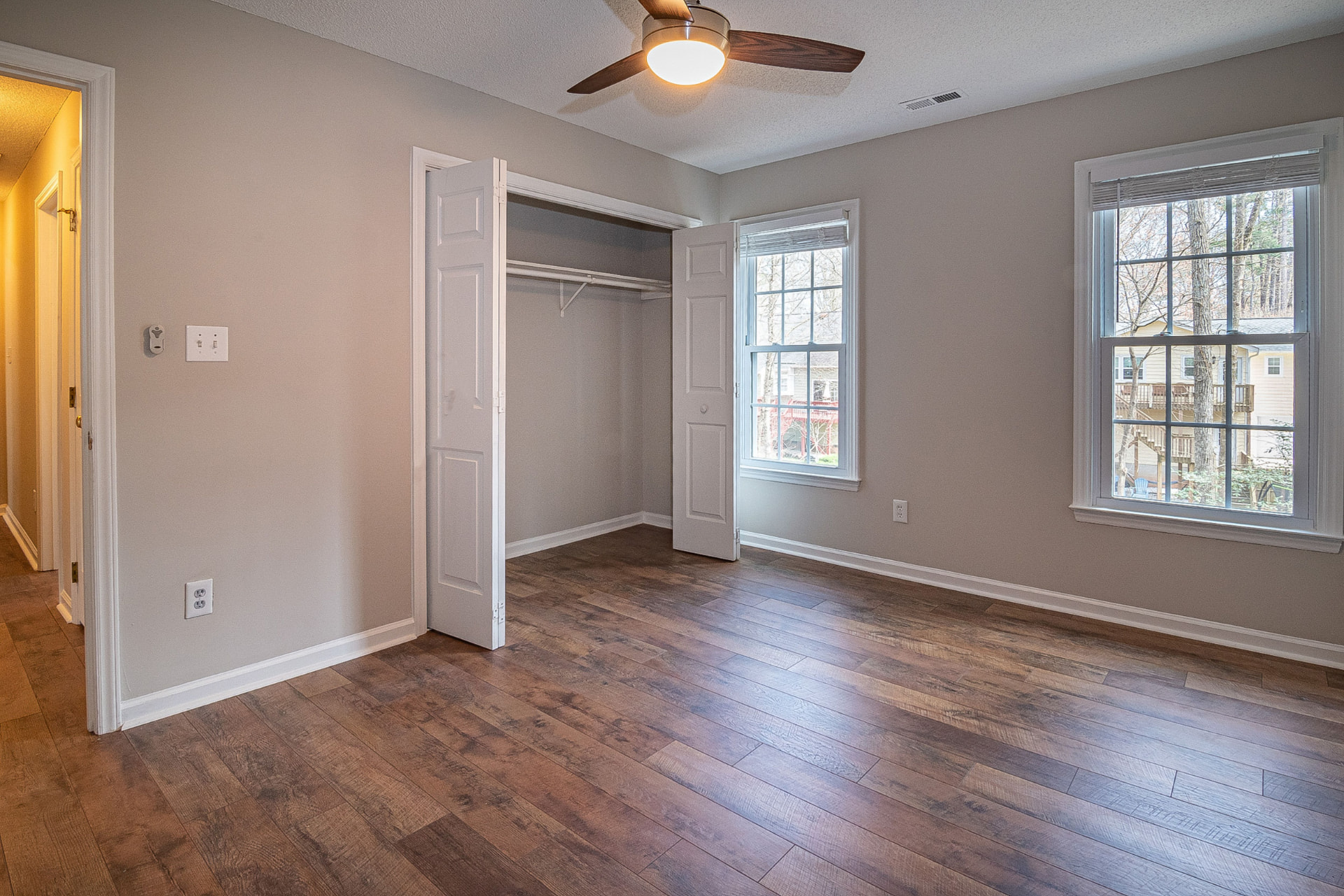 Empty bedroom with open closet and new flooring